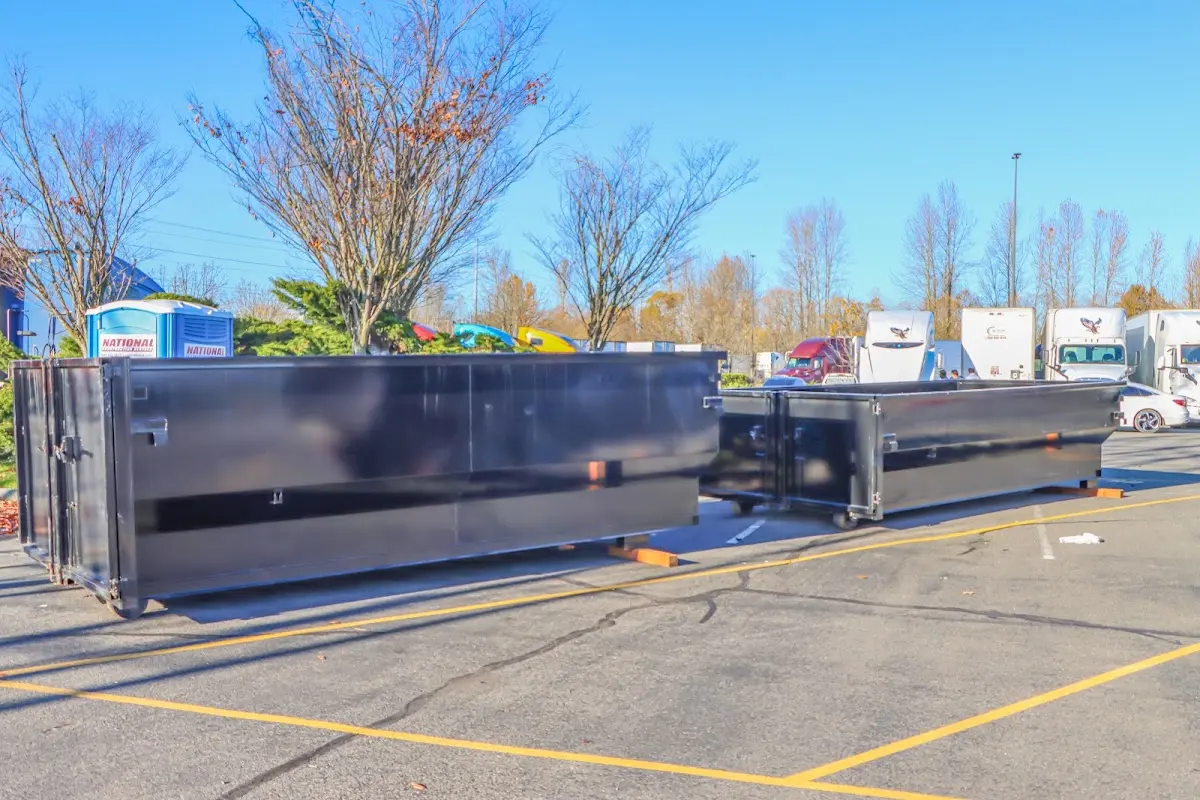 Professional dumpster rental service with roll-off container on residential driveway in Clewiston